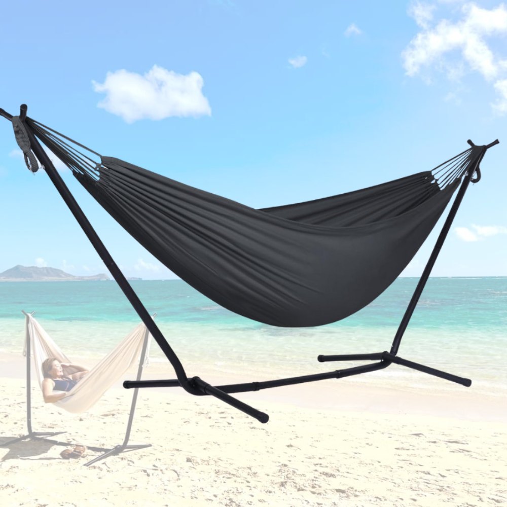 A hammock and its steel stand set up on a lawn